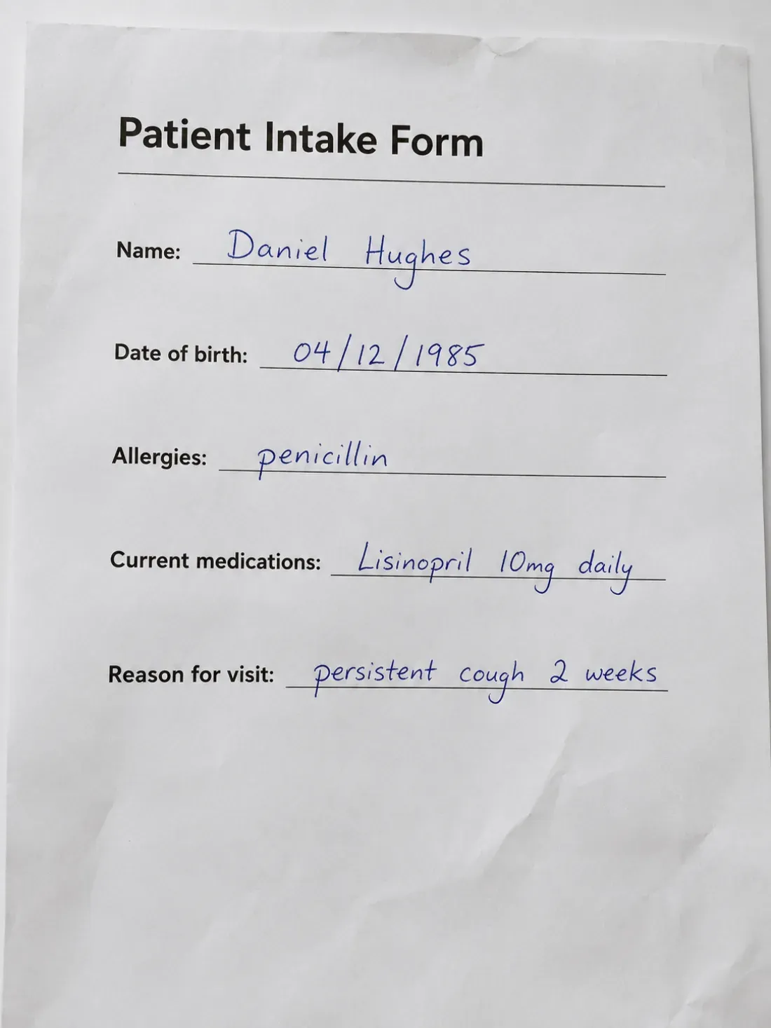 A patient intake form with printed labels and handwritten answers